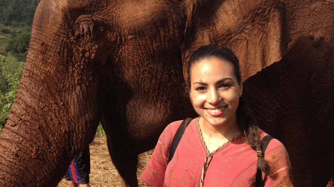 Beautiful woman with elephant in nature